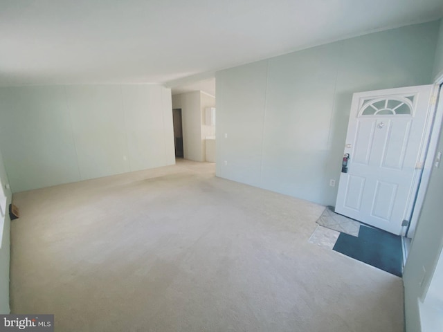 unfurnished room featuring light colored carpet