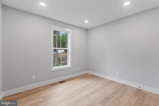 unfurnished room with light wood-type flooring