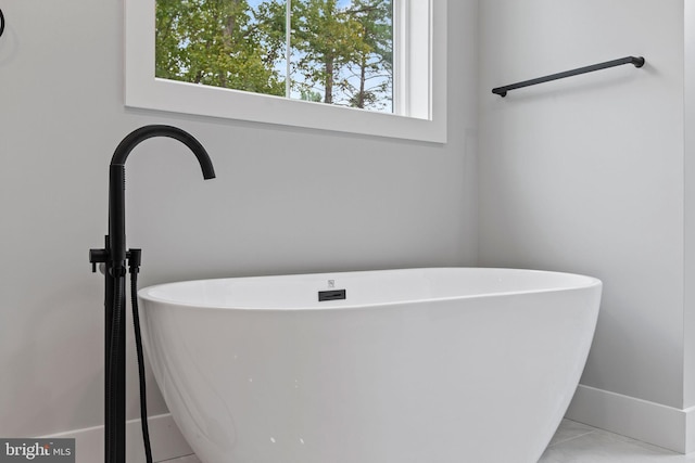 bathroom with tile patterned floors and a bathing tub