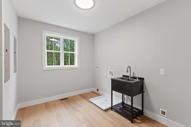 washroom featuring electric dryer hookup, washer hookup, and light wood-type flooring