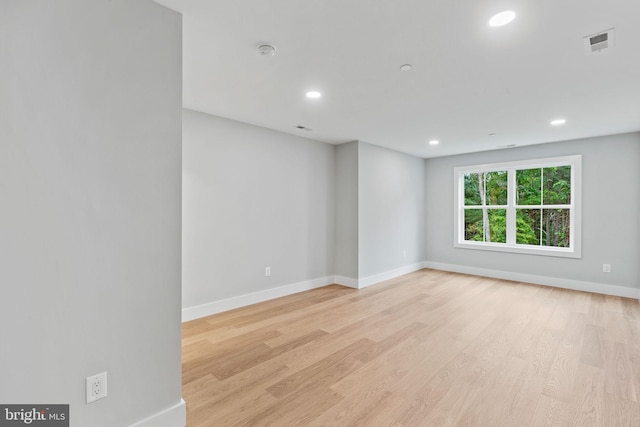 empty room with light hardwood / wood-style flooring