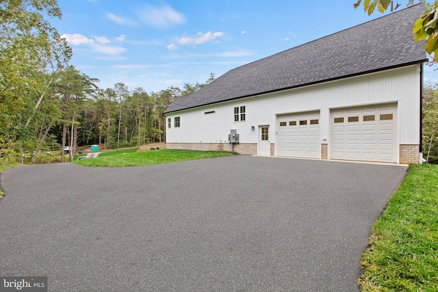 view of home's exterior featuring a lawn and a garage