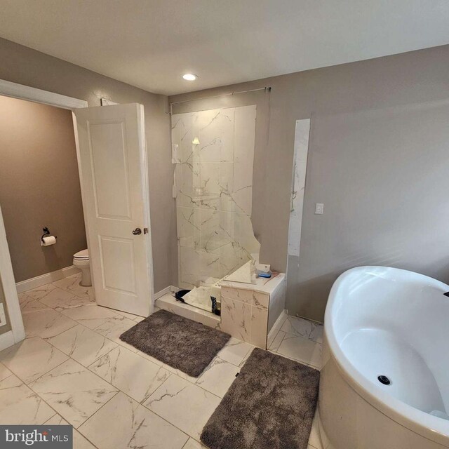 bathroom featuring shower with separate bathtub and toilet