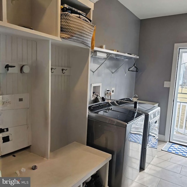 laundry room with separate washer and dryer and light tile patterned floors