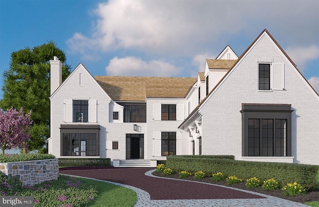 exterior space with brick siding and a chimney