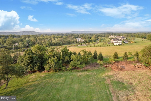 birds eye view of property featuring a mountain view and a rural view