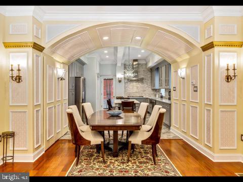 dining room with crown molding and wood-type flooring