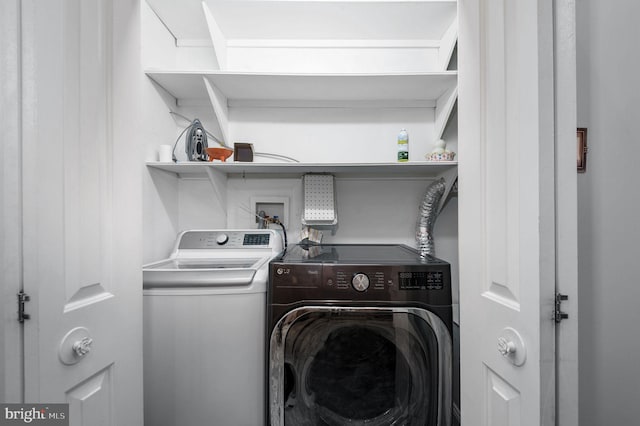 washroom with laundry area and washer and dryer