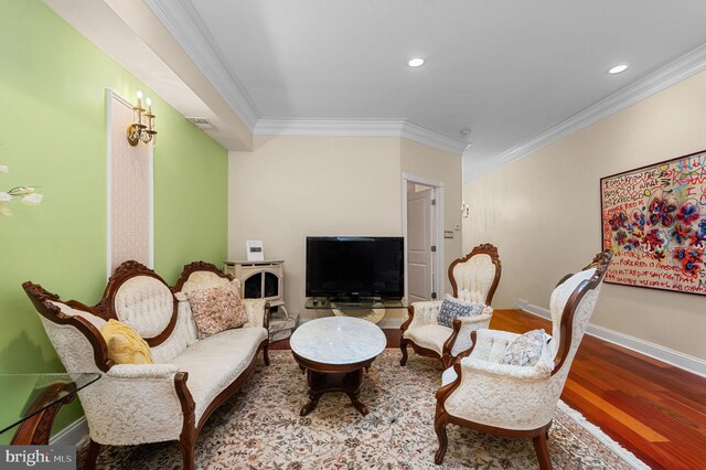 bedroom with light hardwood / wood-style floors, crown molding, and an inviting chandelier