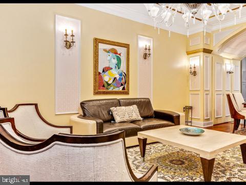 interior space featuring crown molding, hardwood / wood-style floors, and a chandelier