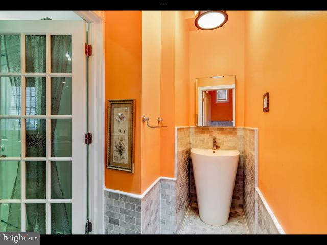 bathroom with tile patterned floors and tile walls