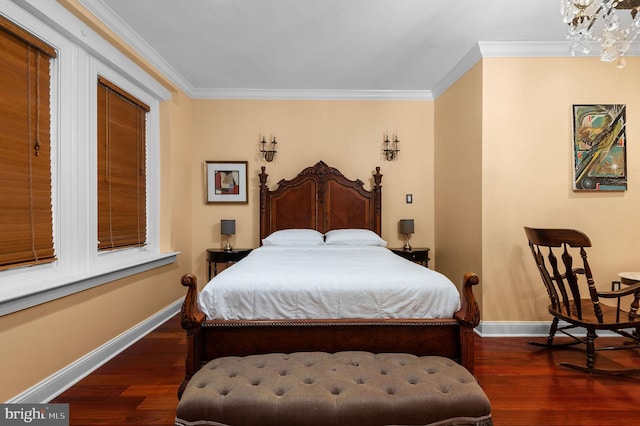 bedroom featuring baseboards, ornamental molding, and dark wood finished floors