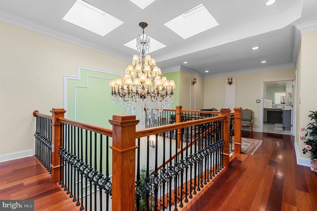 living area with ornamental molding and wood-type flooring