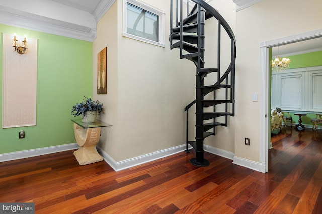 stairway with ornamental molding, wood finished floors, and baseboards