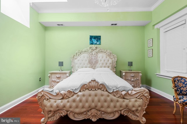 bedroom featuring dark wood finished floors, visible vents, and baseboards