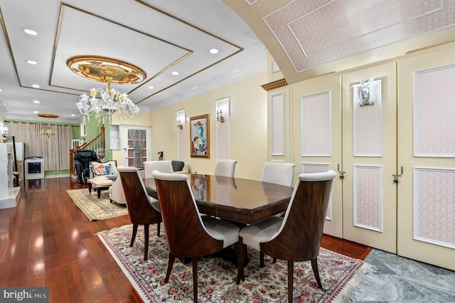 dining space featuring recessed lighting, wood finished floors, ornamental molding, french doors, and an inviting chandelier