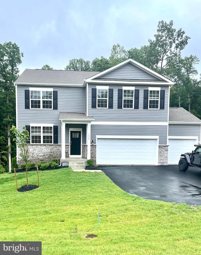 view of front of home with a garage and a front yard