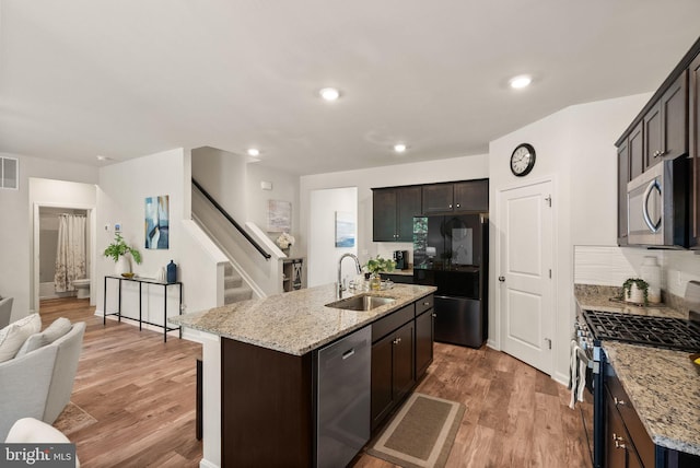 kitchen with sink, appliances with stainless steel finishes, and light hardwood / wood-style floors