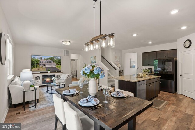 dining area featuring light hardwood / wood-style floors and sink