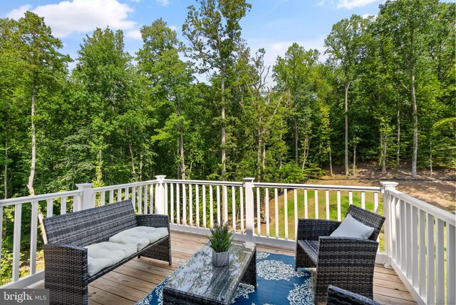 wooden terrace featuring an outdoor hangout area