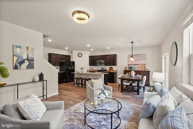 living room with light hardwood / wood-style flooring and sink