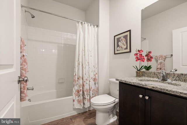 full bathroom with vanity, toilet, wood-type flooring, and shower / bath combo with shower curtain