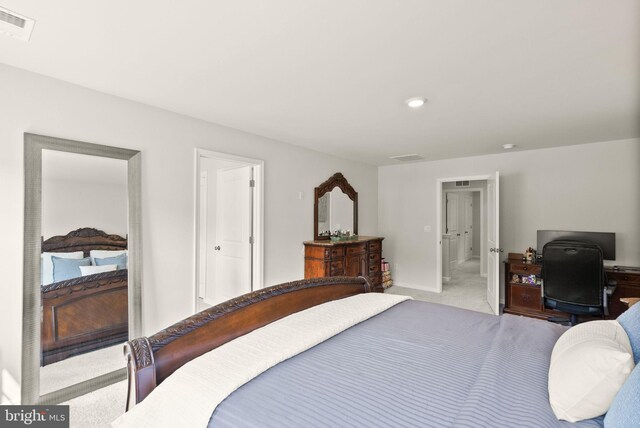 carpeted bedroom with baseboards and visible vents