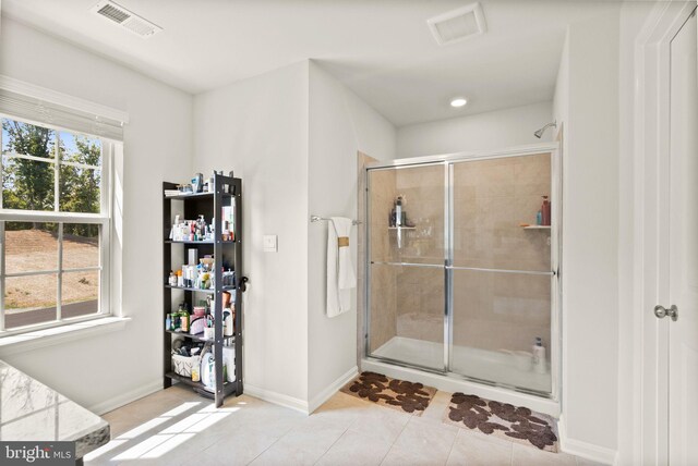 bathroom featuring an enclosed shower and tile patterned floors