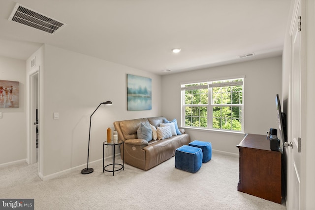 carpeted living room featuring visible vents and baseboards