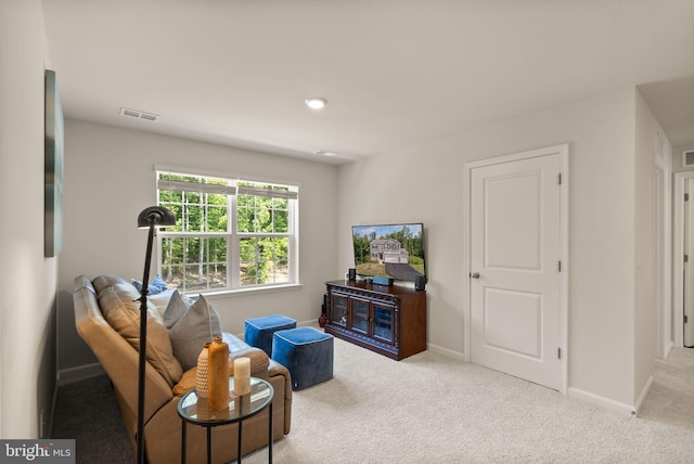 carpeted living room with baseboards and visible vents