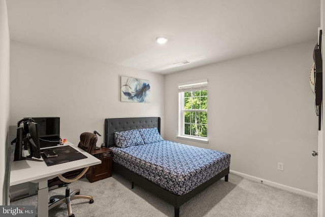 bedroom featuring light carpet, visible vents, and baseboards