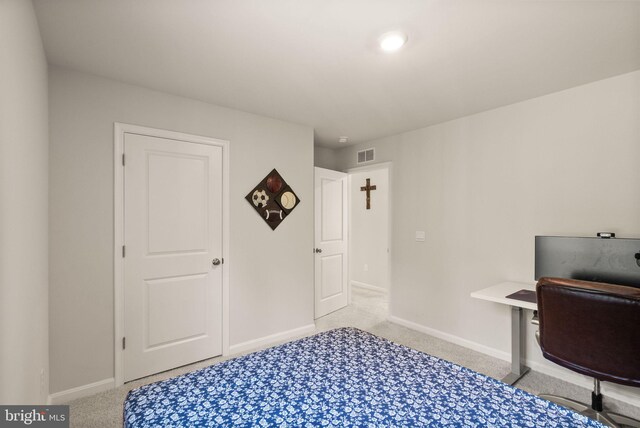 bedroom with light colored carpet