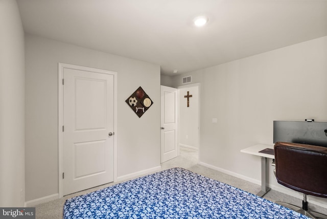 carpeted office with baseboards and visible vents