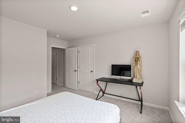 bedroom featuring light colored carpet