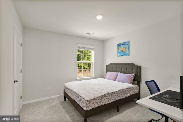 bedroom with baseboards, visible vents, and carpet flooring