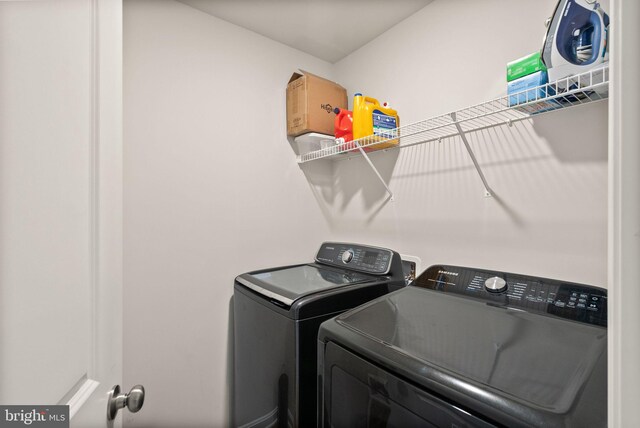 clothes washing area featuring washing machine and clothes dryer