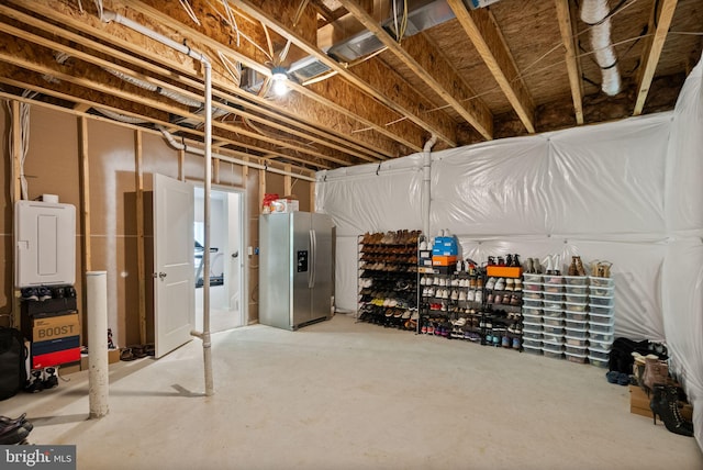 unfinished below grade area with stainless steel fridge with ice dispenser