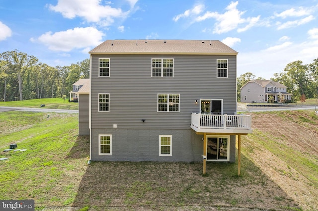 back of house with a lawn and a wooden deck