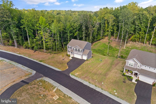 birds eye view of property featuring a wooded view