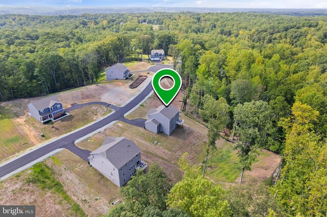 birds eye view of property with a wooded view