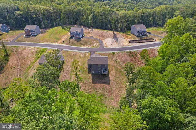 drone / aerial view featuring a forest view