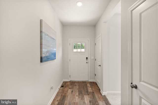 entryway with dark wood-style flooring and baseboards