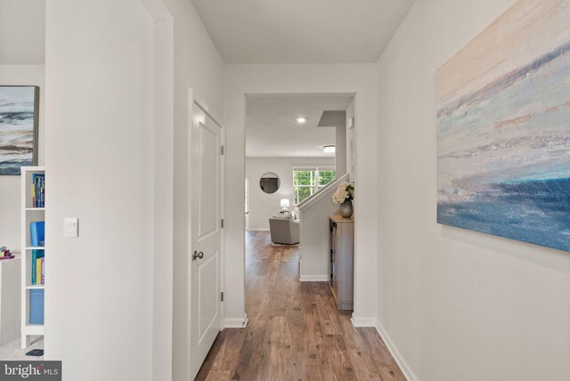 corridor with hardwood / wood-style floors