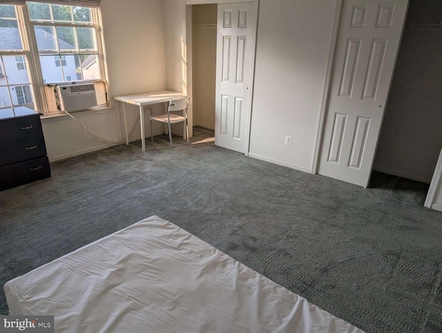 bedroom with dark colored carpet, cooling unit, and a closet