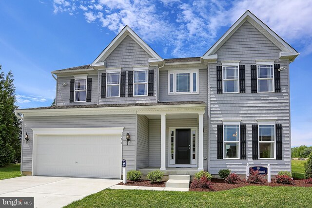 view of front of house with a garage and a front yard