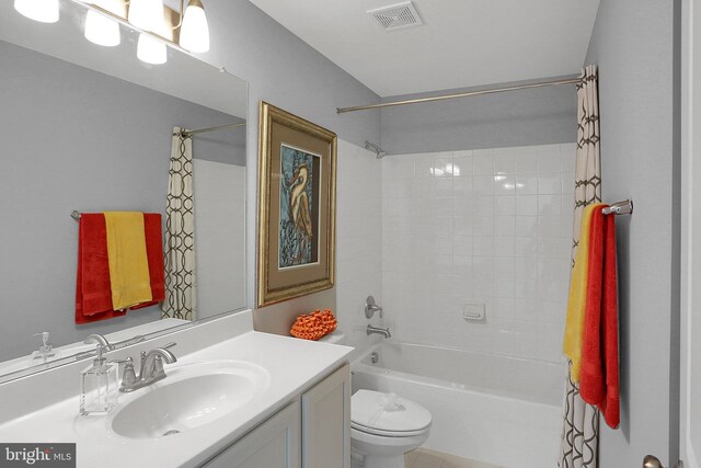 full bathroom with tile patterned flooring, toilet, shower / tub combo with curtain, and vanity