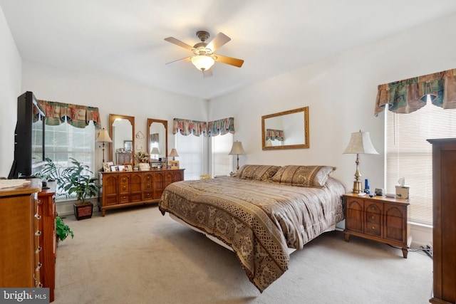 bedroom featuring ceiling fan and light carpet