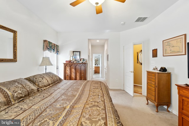 bedroom with a walk in closet, a closet, ceiling fan, and light carpet