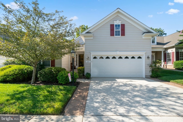 front of property featuring a garage and a front lawn