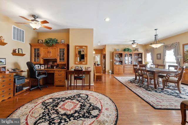 dining space with ceiling fan and light hardwood / wood-style floors